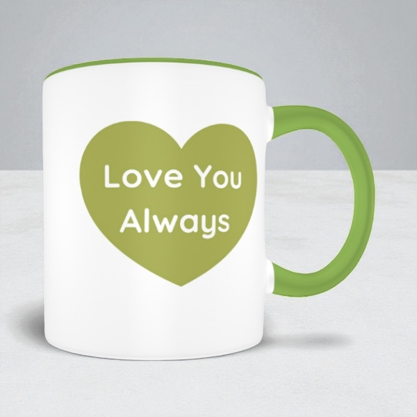 White mug with green heart and text 'Love You Always' on a light gray background