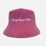 Pink bucket hat with 'Allergy Mum Club' text on a light purple background