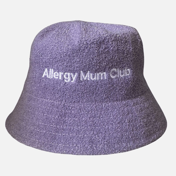 Purple bucket hat with 'Allergy Mum Club' text on a light gray background