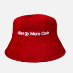 Red bucket hat with 'Allergy Mum Club' text on a light gray background