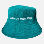 Teal bucket hat with 'Allergy Mum Club' text on a light gray background