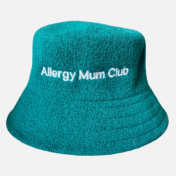 Teal bucket hat with 'Allergy Mum Club' text on a light gray background