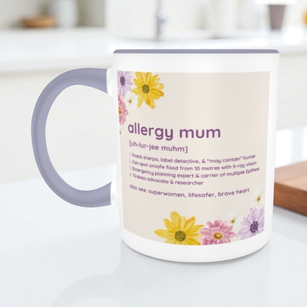 Mug with 'allergy mum' definition and floral design on a white surface