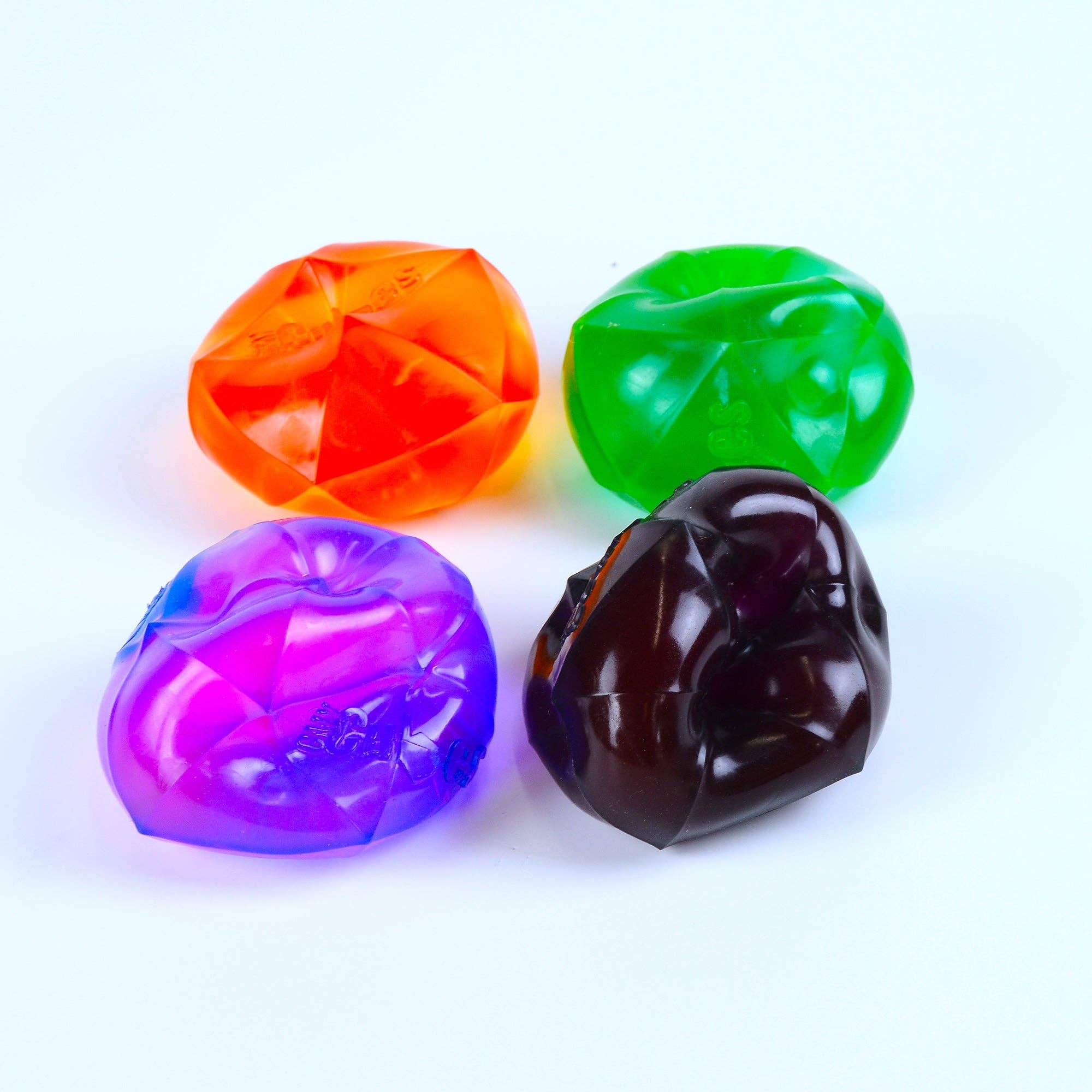 Four colorful translucent CMY Cubes PolySquish on a white background