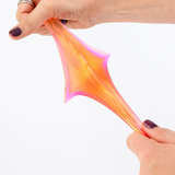 Colorful slime being stretched between two hands on a white background