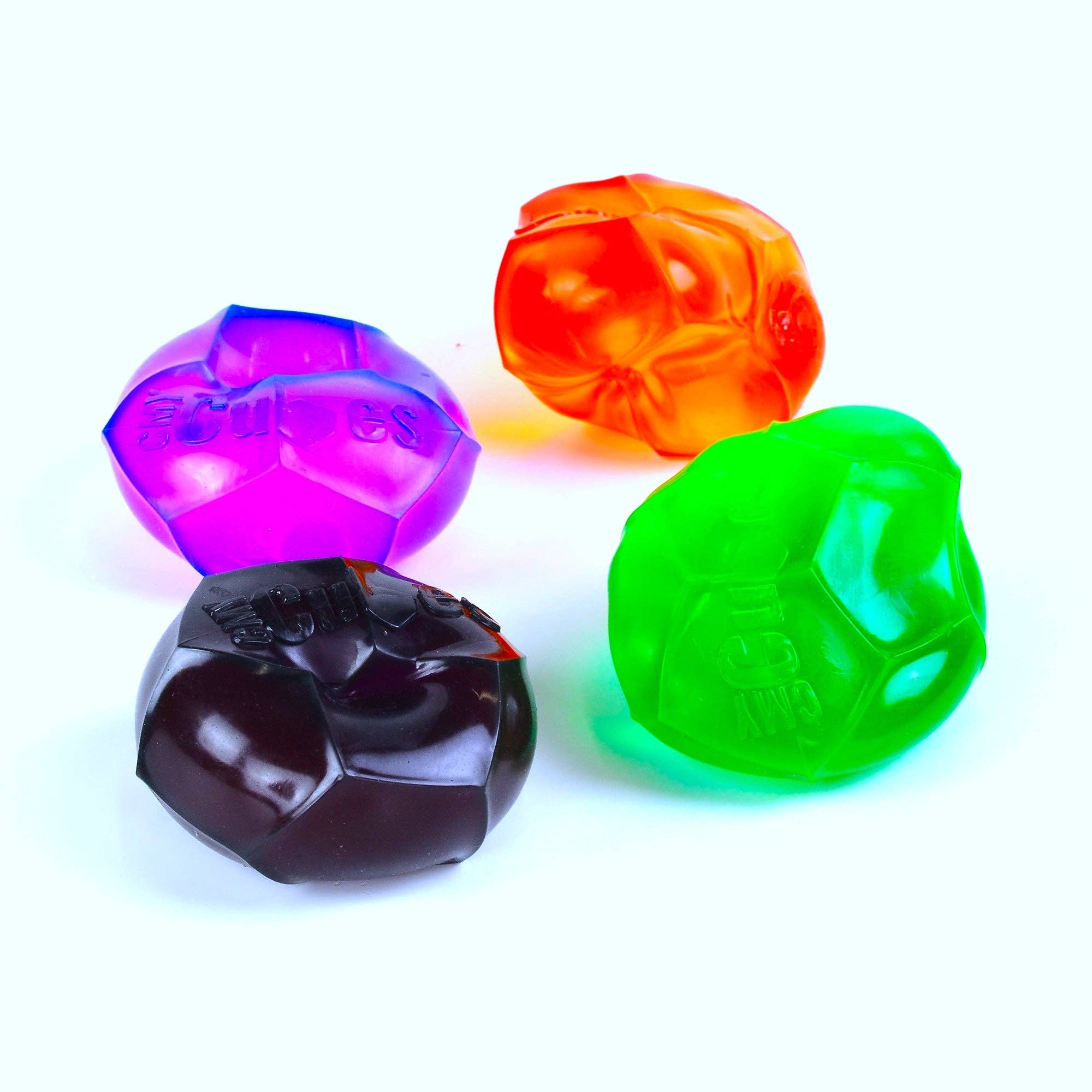 Four colorful plastic toys on a white background