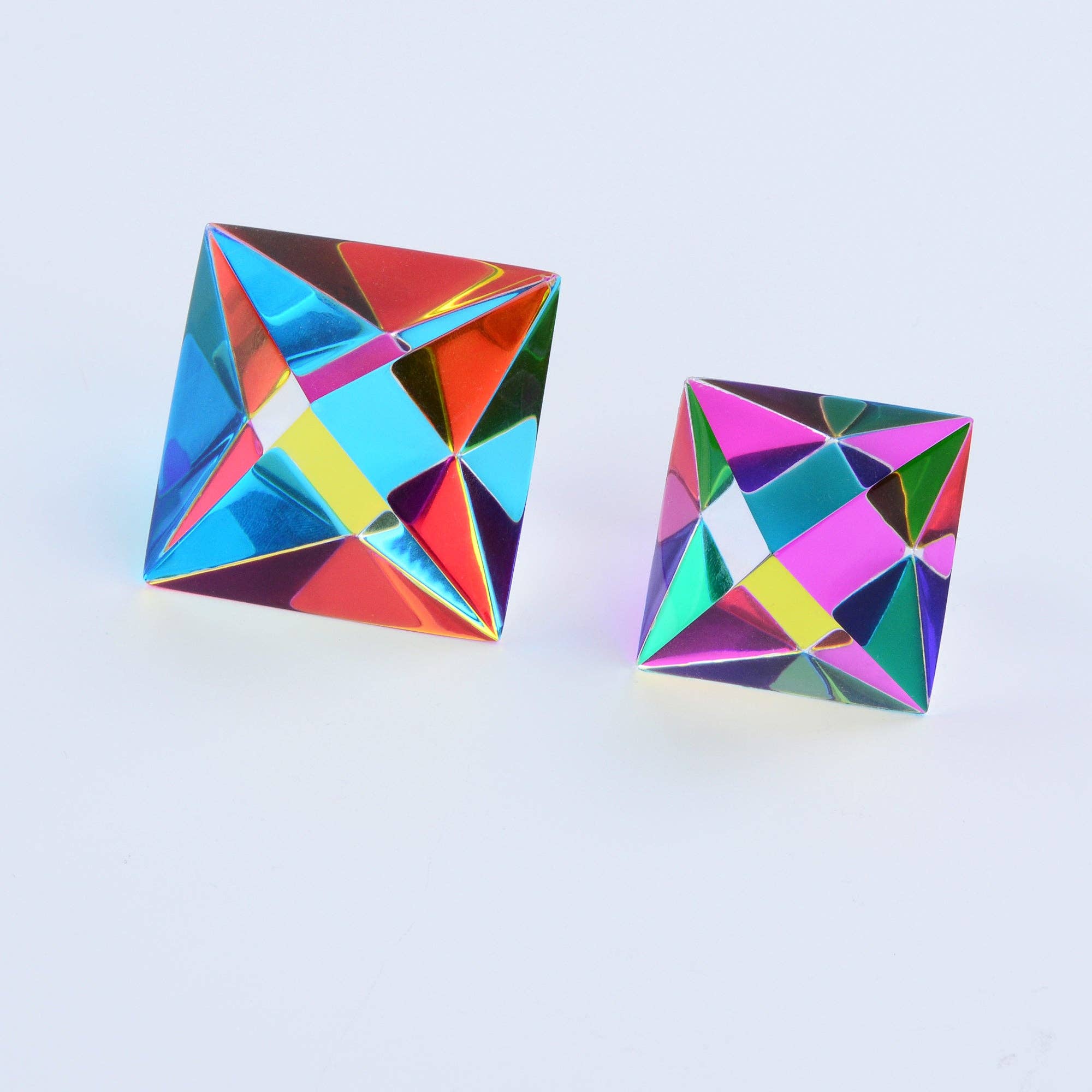Multicolored geometric toys on a light blue background