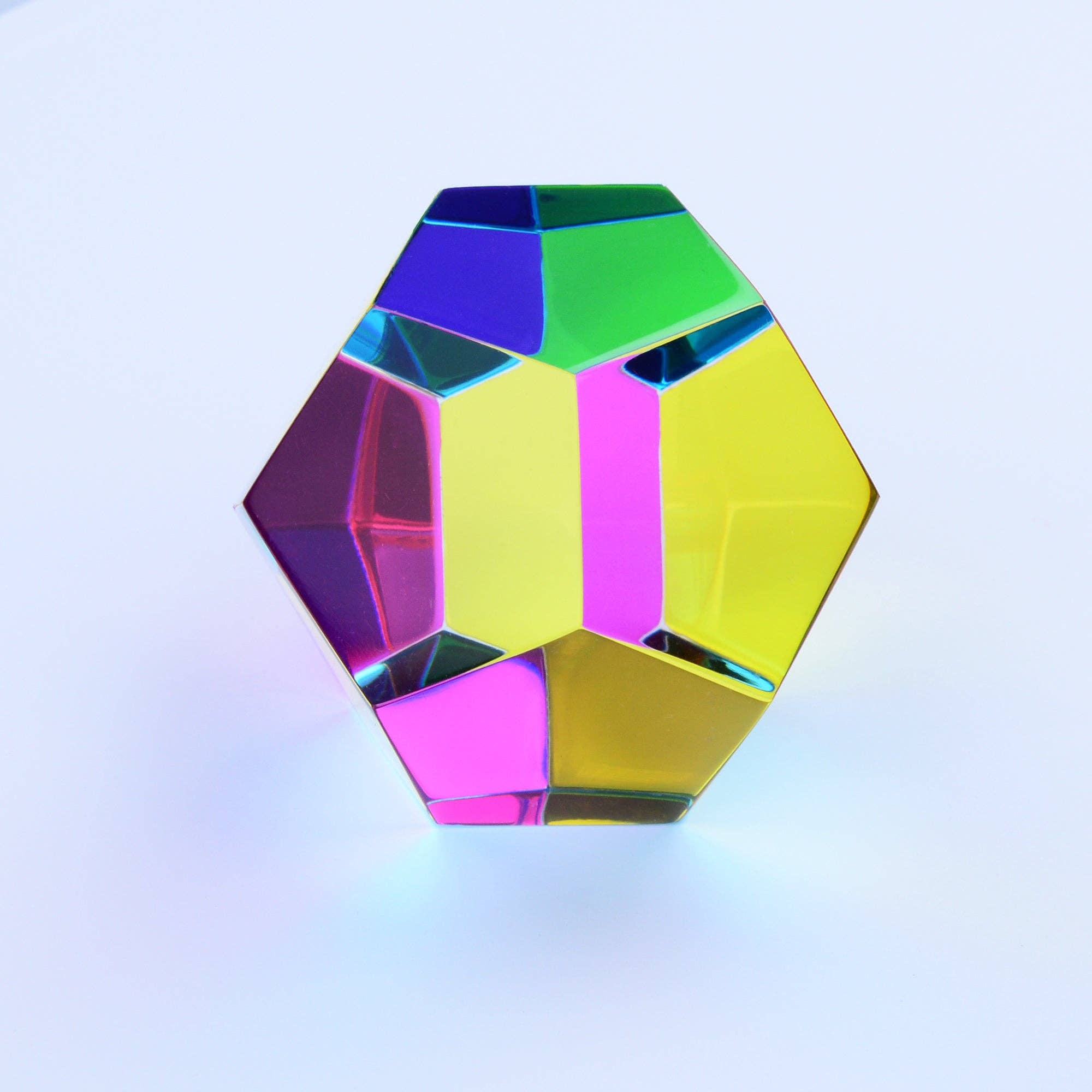 Multicolored geometric crystal on a light blue background