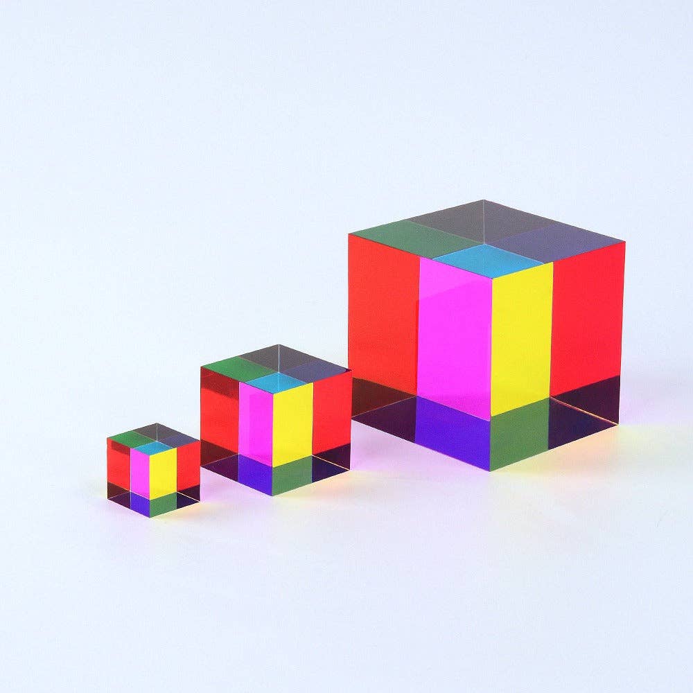 Set of three colorful transparent cubes on a light gray background
