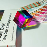 Colorful geometric object on a book titled 'Pantone: The 20th Century in Color' with color swatches in the background.