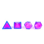 Set of four colorful polyhedral dice on a white background