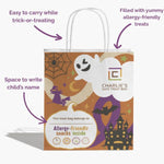 Halloween-themed treat bag with Charlie's Safe Treat Box branding, featuring ghost, witch, and castle illustrations.