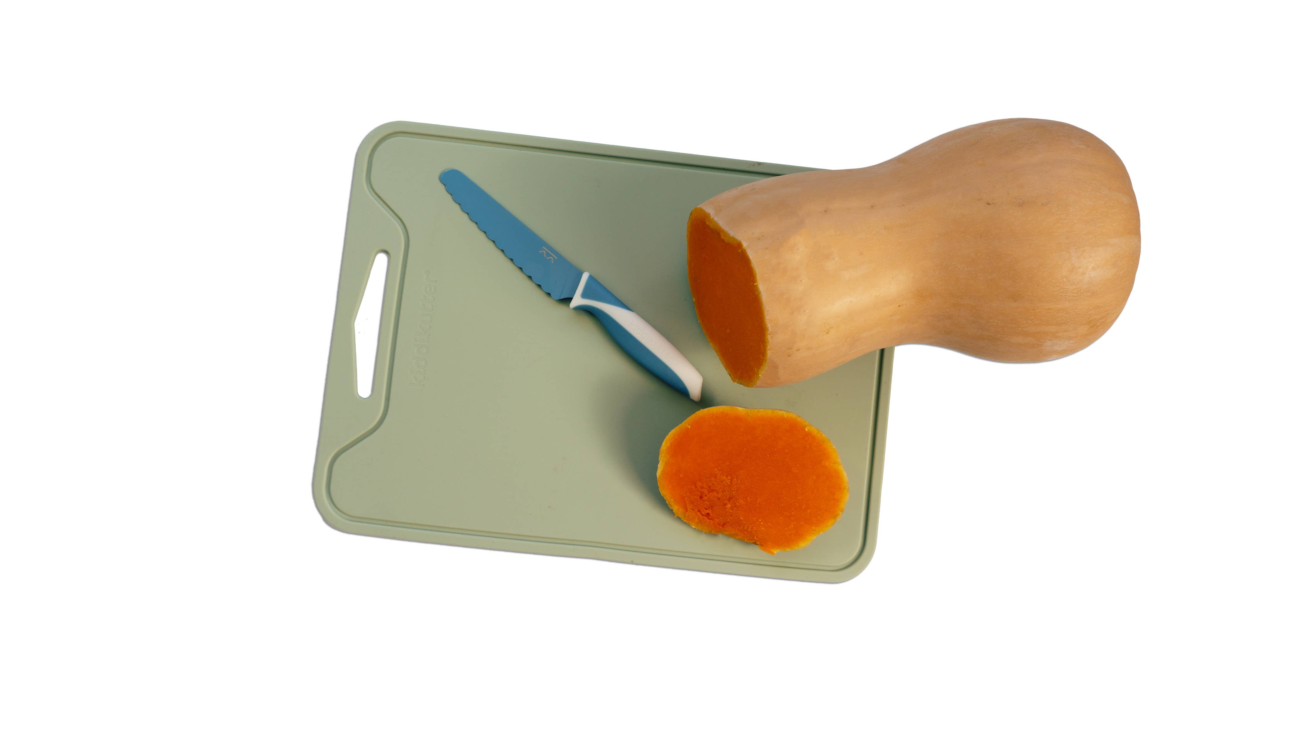A light green rectangular cutting board with a handle cutout, shown on a white background with a butternut squash half, a carrot slice, and a blue-handled knife.