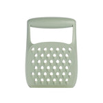 A sage green silicone kitchen grater with a handle, shown against a plain white background.