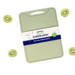 A light green kiddikutter non-stick cutting board with a white and navy paper label, shown on a white background with floating sliced kiwi fruit illustrations around it.
