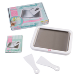 Ice cream maker set with tray, spatulas, and packaging on a white background