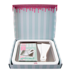Open box containing an ice cream maker with a striped design on the lid.