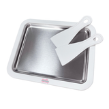 Stainless steel baking pan with white spatula on a white background