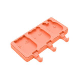 Coral-colored ice cream mold with bear and square shapes on a white background