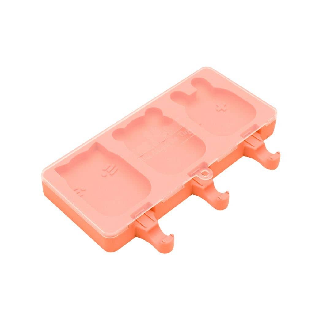 Peach-colored popsicle mold on a white background