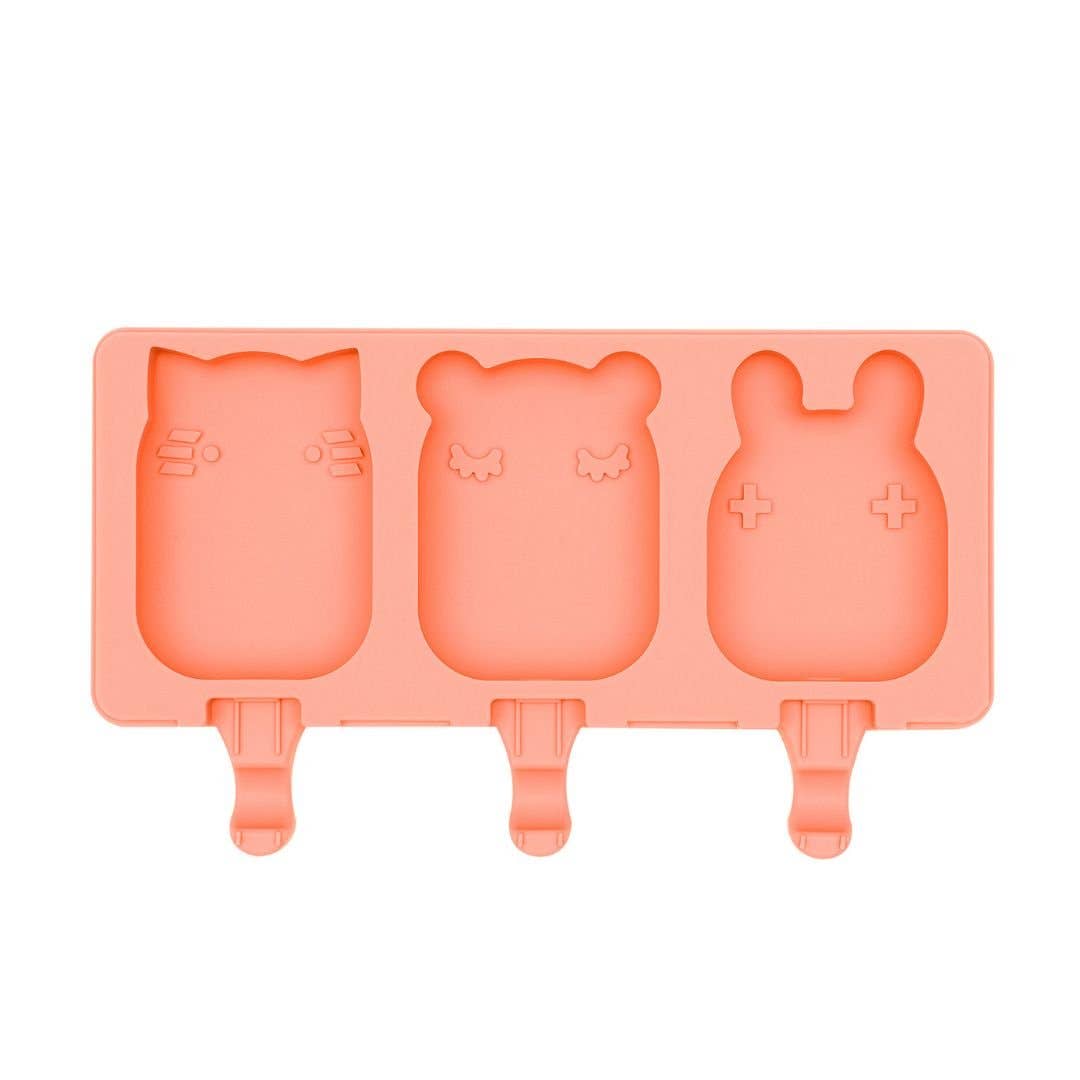 Coral silicone mold with bear, fox, and rabbit shapes on a white background