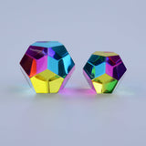 Two colorful geometric objects on a light gray background